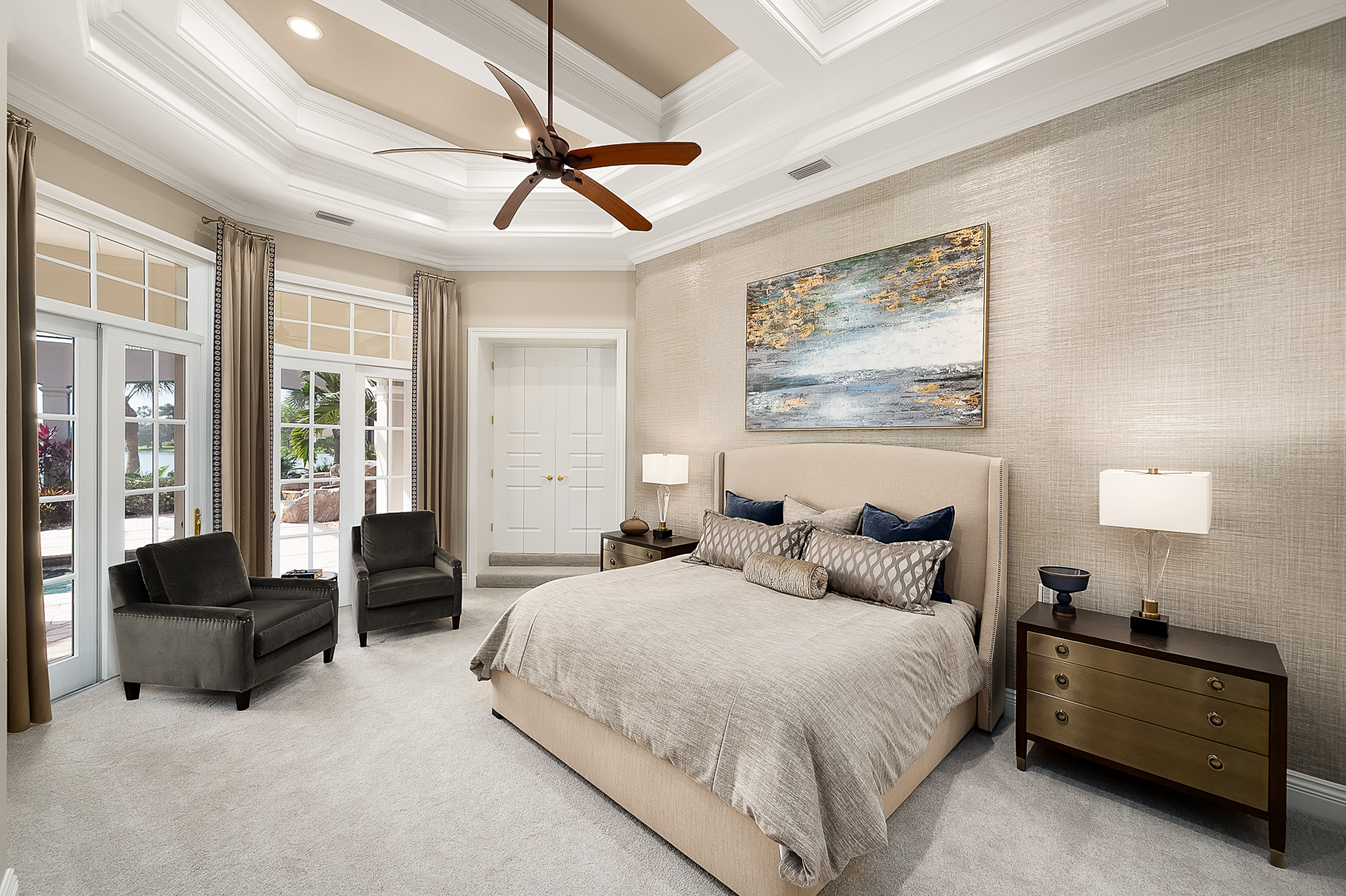 The main floor master suite features a silver and gold textured wallpaper that changes as you walk throughout the room