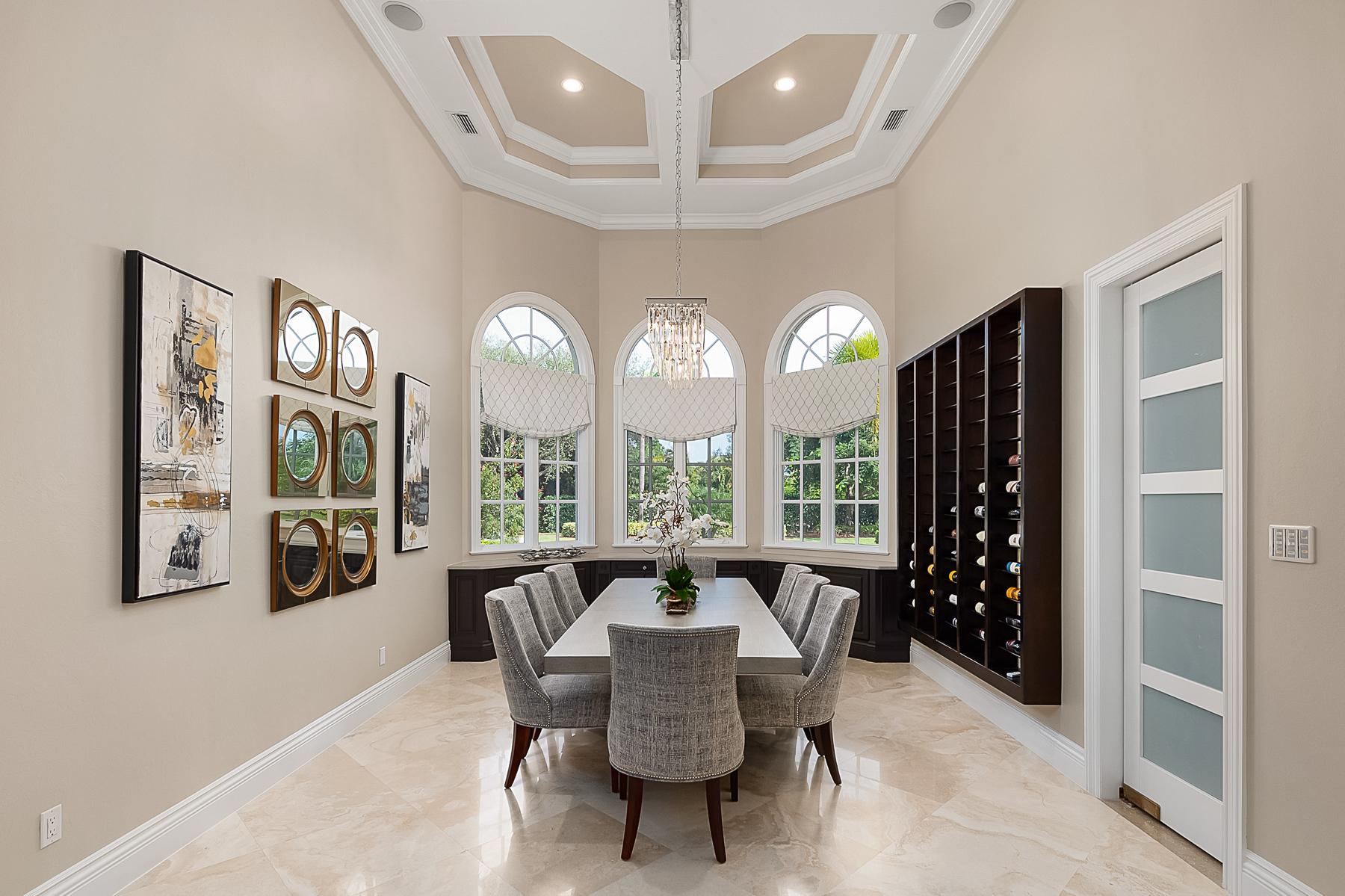 Another dining room focal point is a custom backlit wine rack that displays a collection of favorite wines