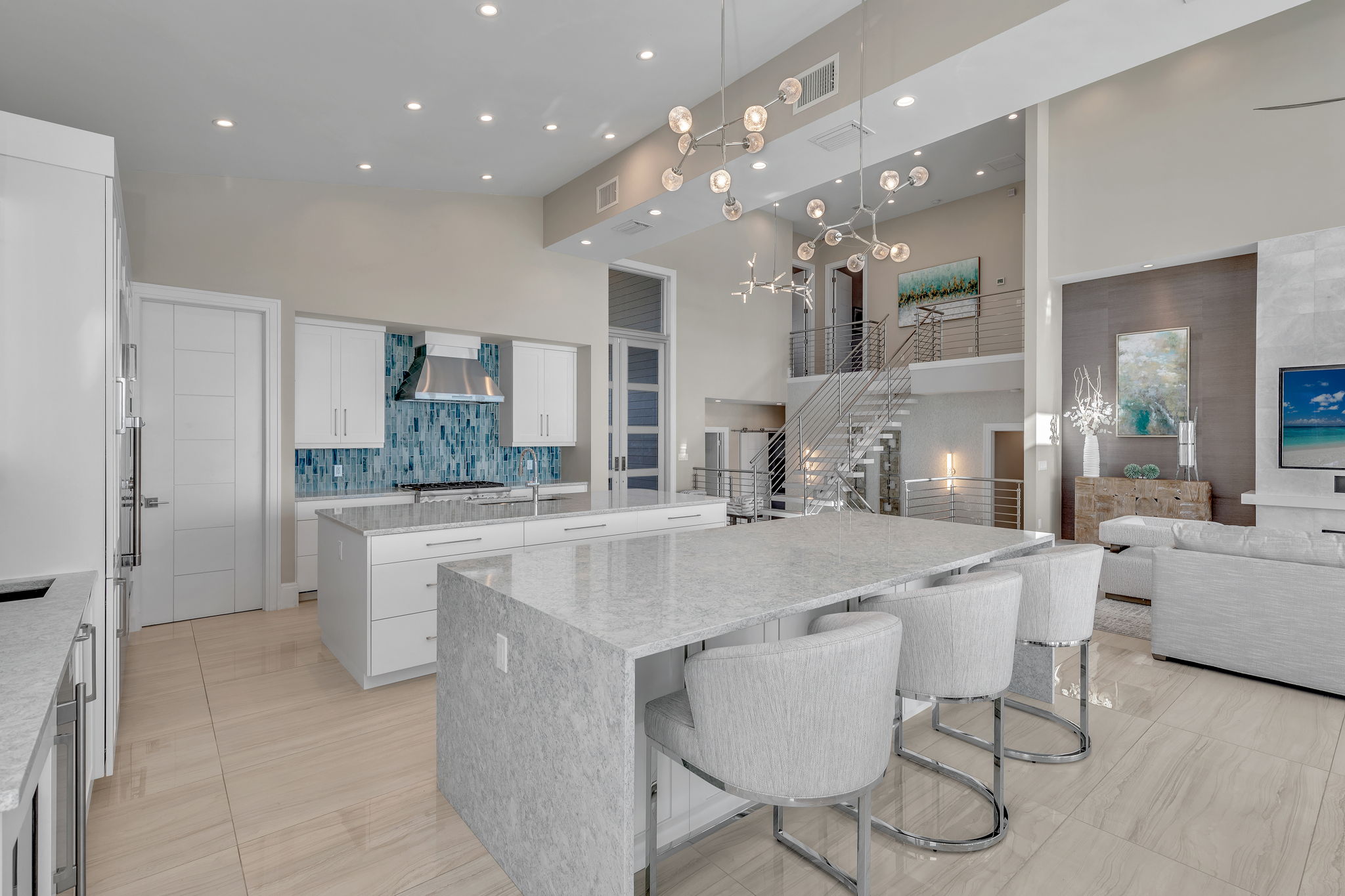 The kitchen backsplash tile features soft blues and aquas, reflecting the surrounding environment