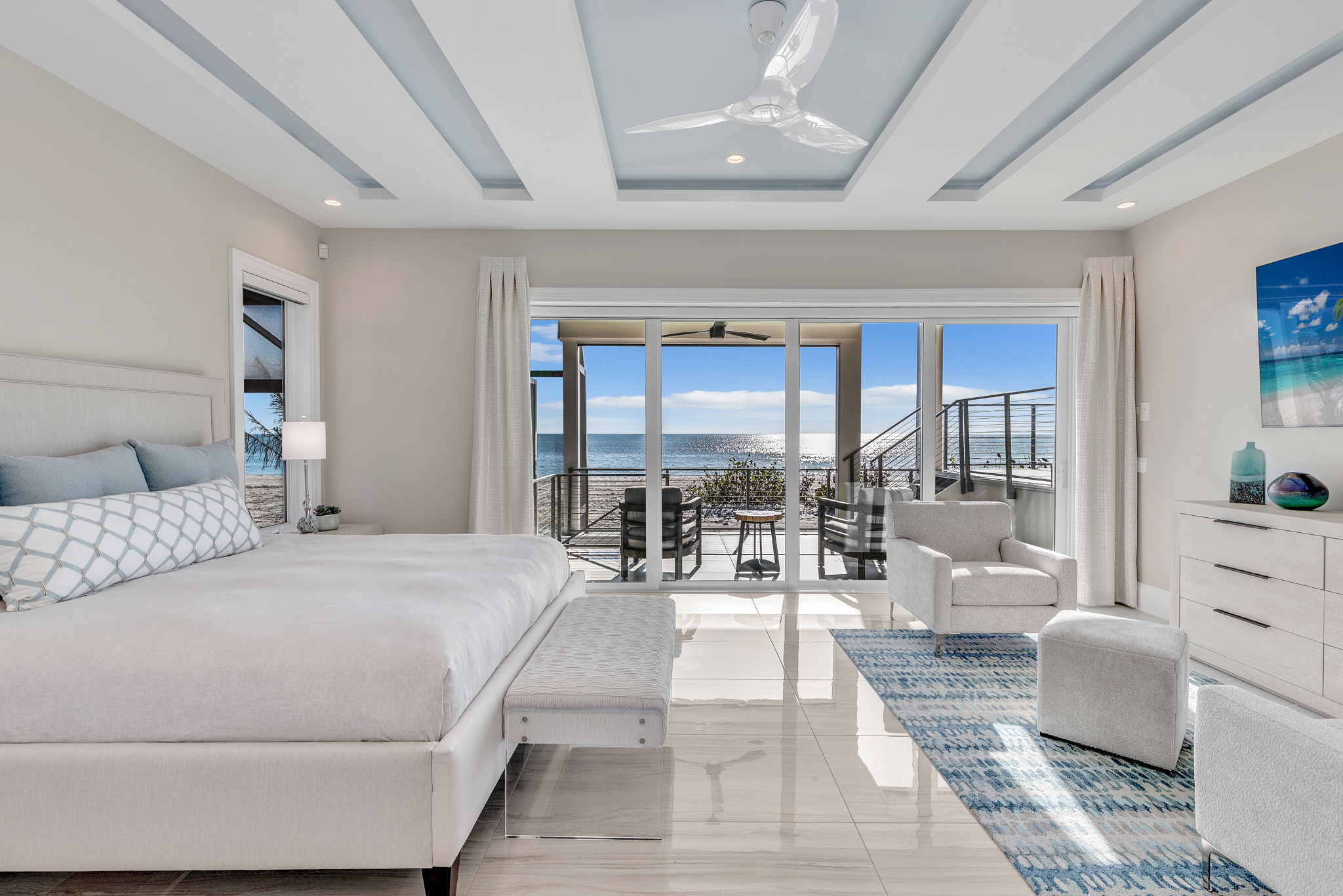 Stunning ocean views in the master bedroom are complemented by soft blues, including the stepped ceiling